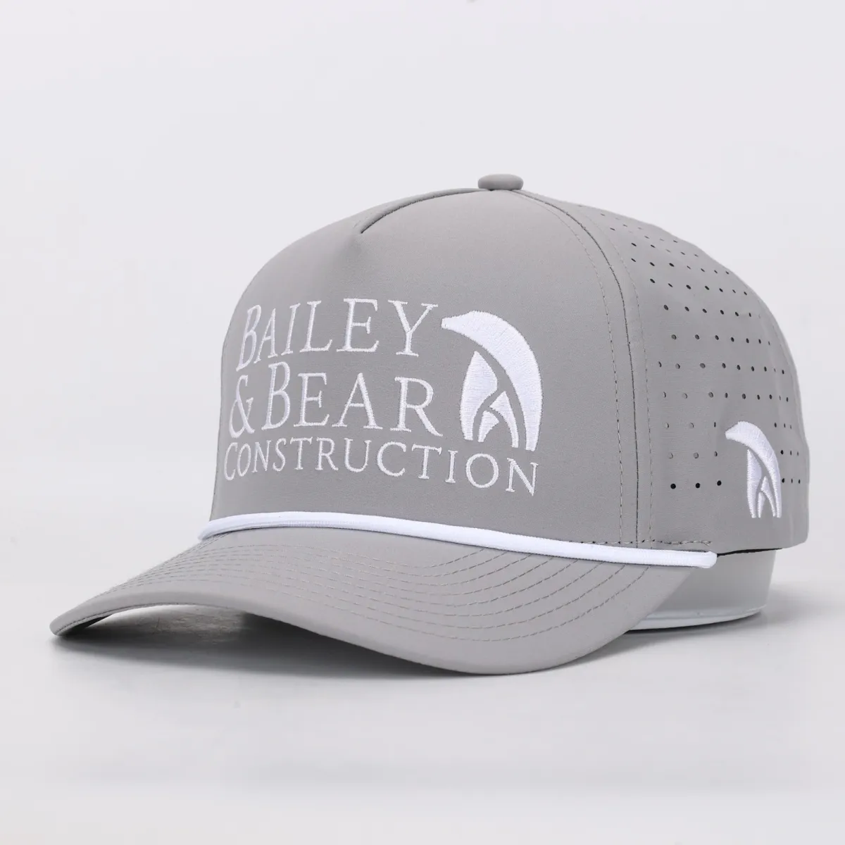 Grey perforated rope cap with Bailey & Bear Construction embroidered in white, and the bear mark repeated on the side